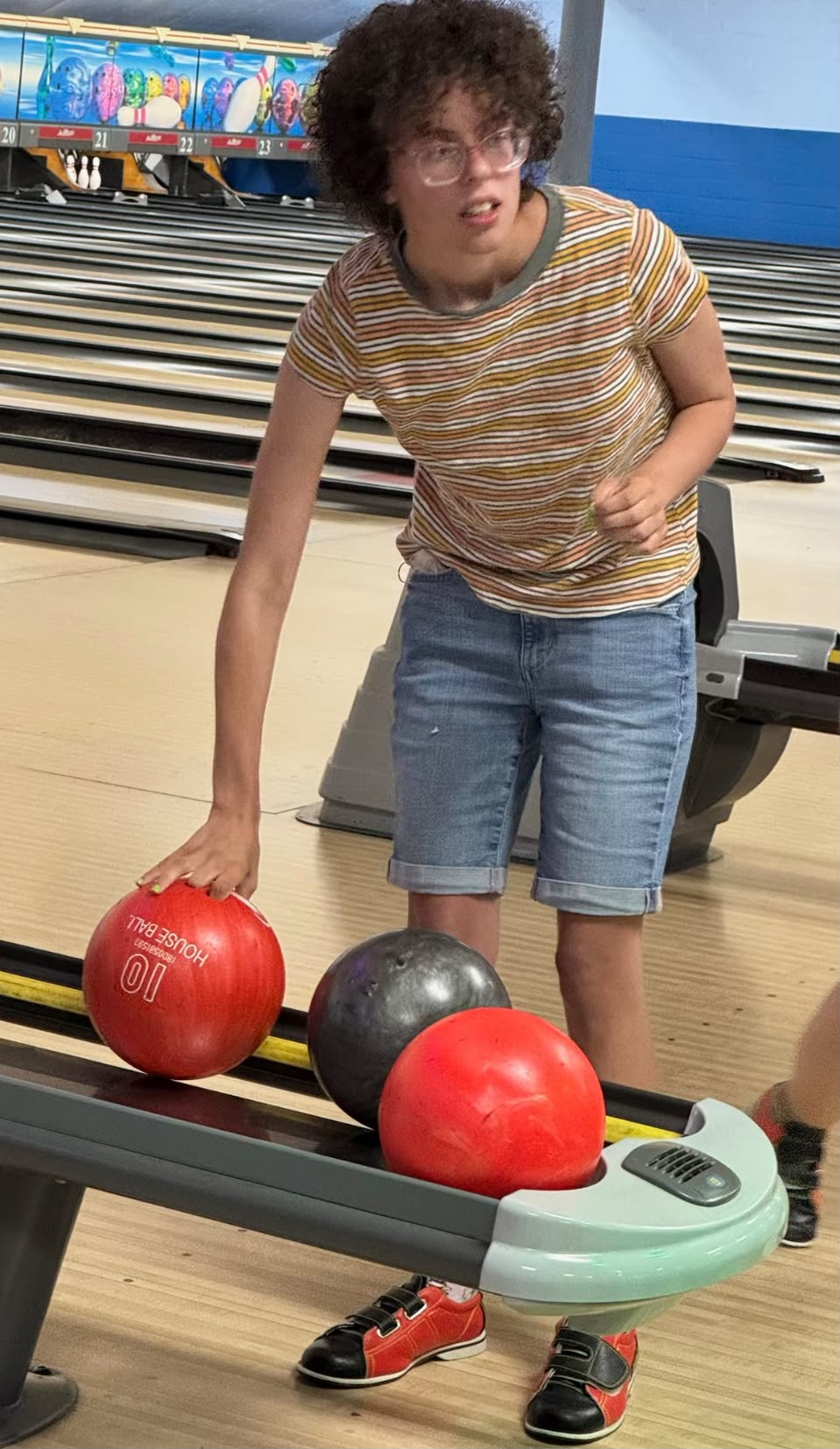 A participant smiling during a bowling outing