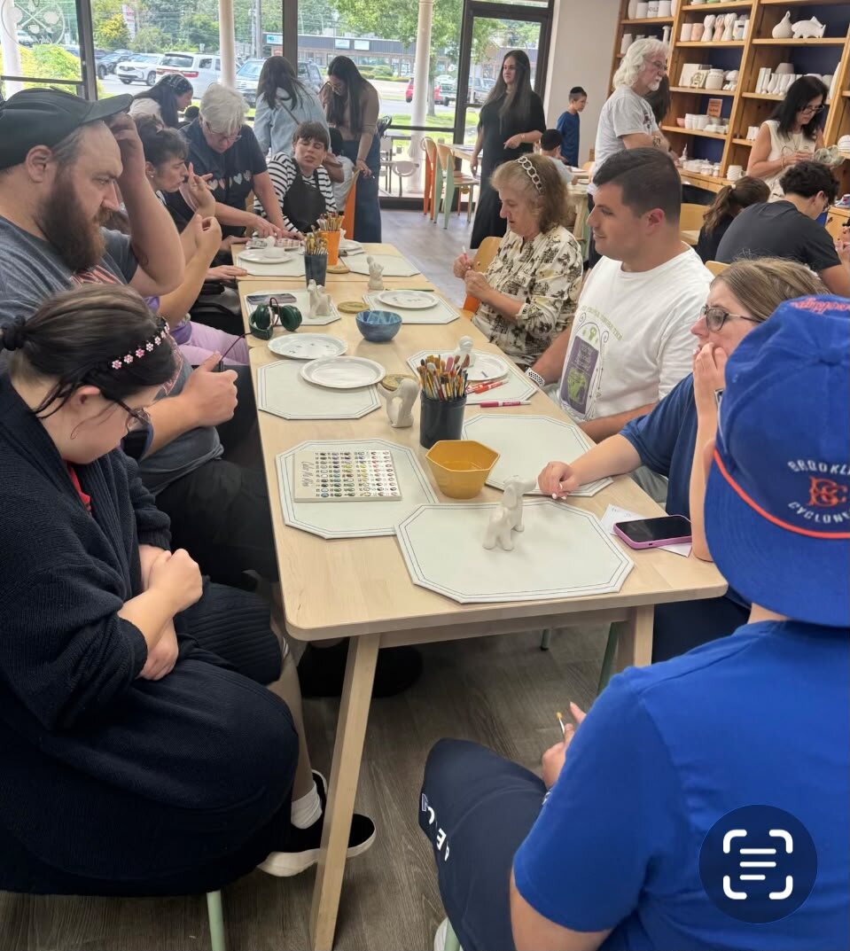 Participants gathered around a table for a group activity
